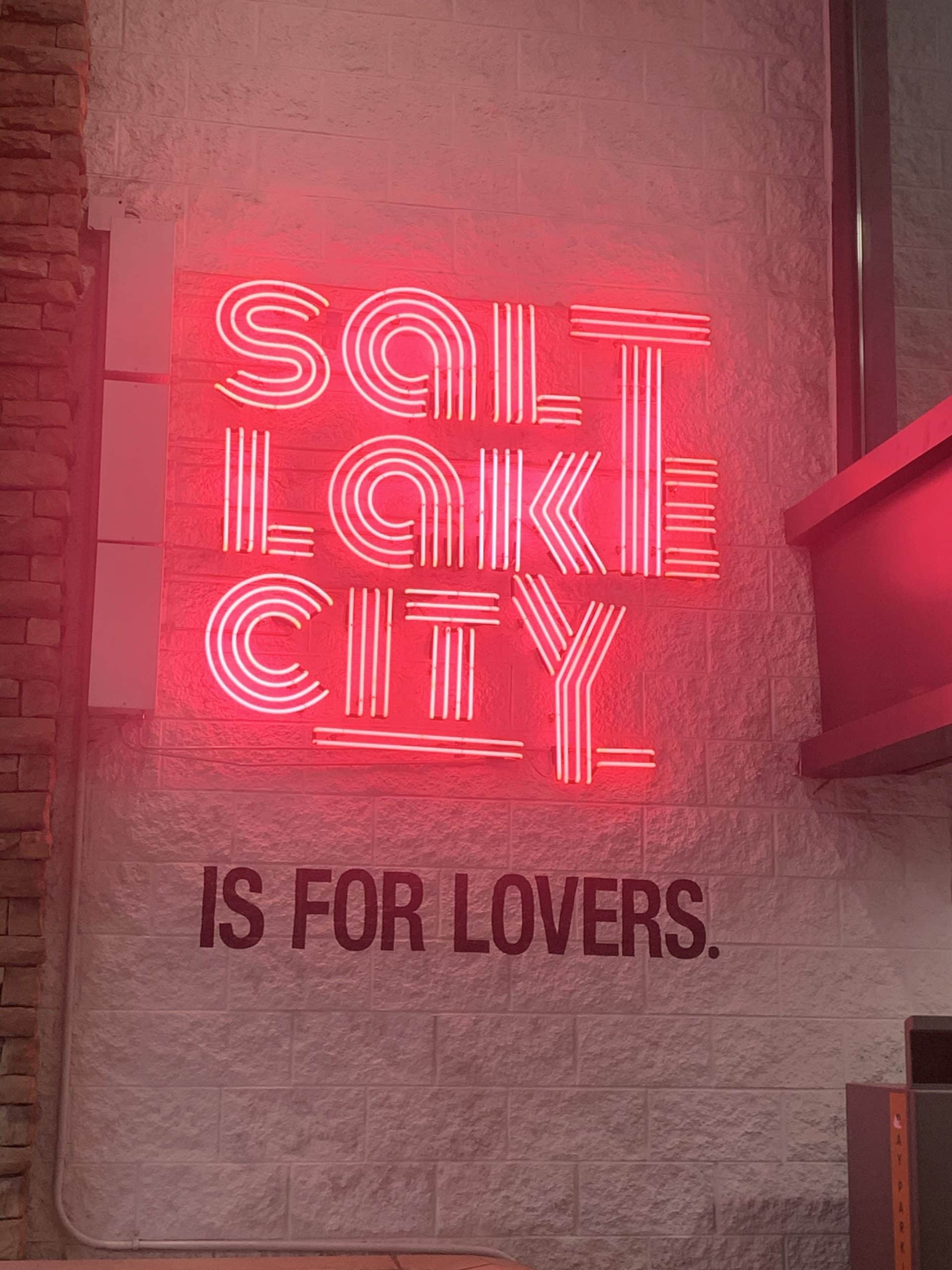 a glowing neon sign that reads "Salt Lake City is for lovers."